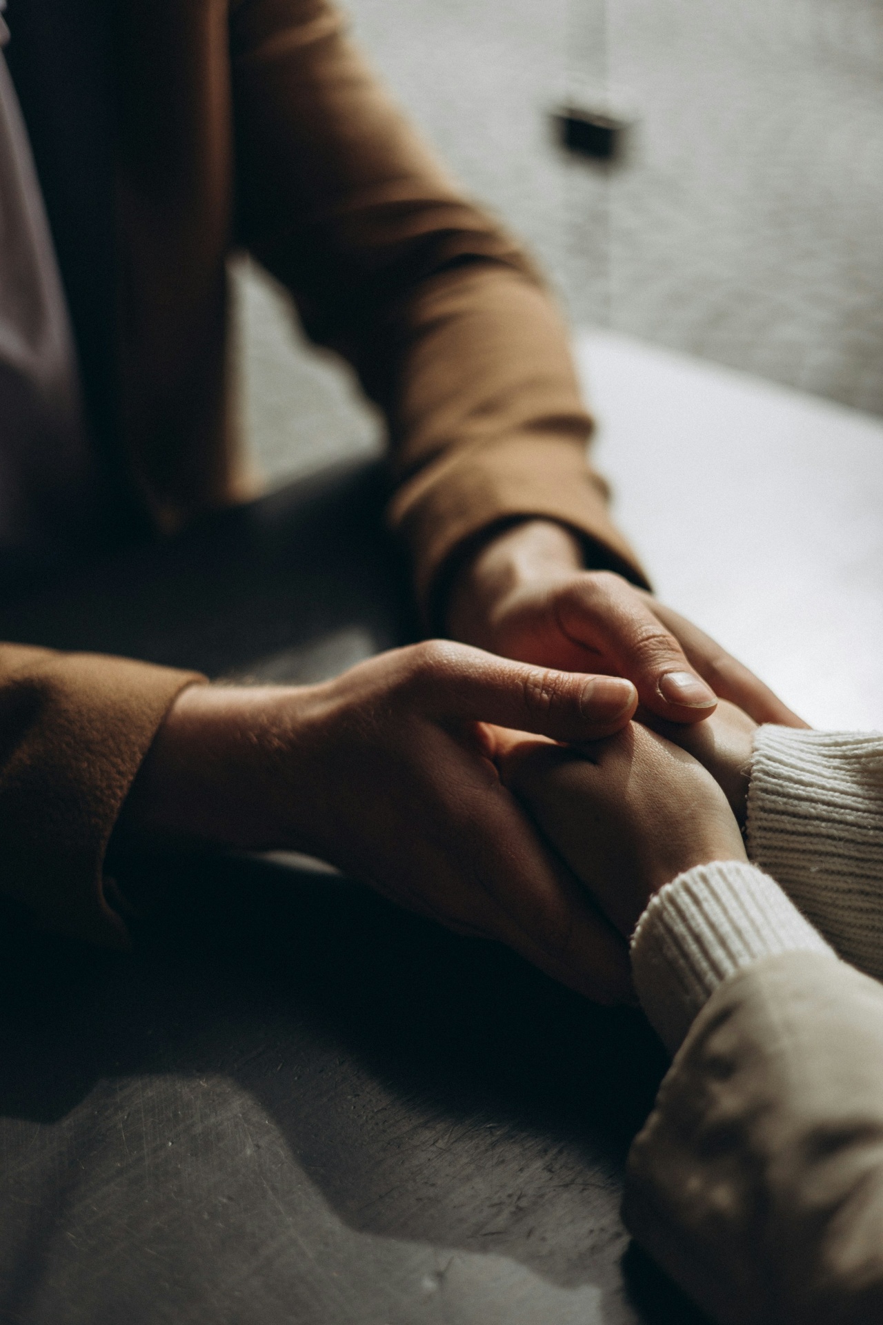 Two people holding hands in a moment of connection and support